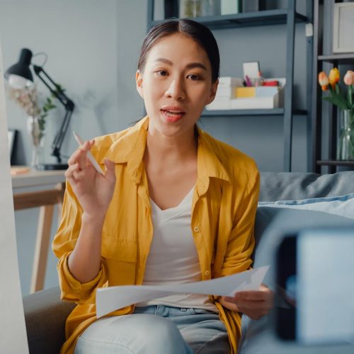 Young Asia lady english teacher video conference calling on smartphone talk by webcam learn teach in online chat at home. Remote classroom, Social distancing, quarantine for corona virus prevention.