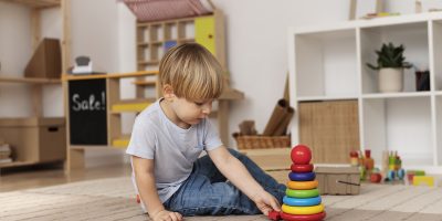 full-shot-little-kid-playing-with-wooden-toy